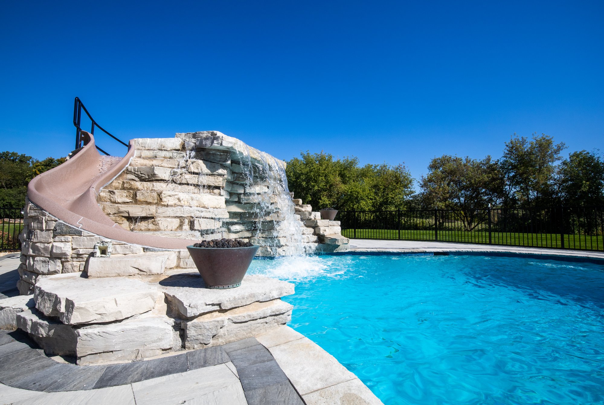 Resort-style pool with natural stone waterfall and slide North Shore IL